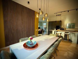 a dining room with a table and chairs at Luxe vakantievilla met jacuzzi in Zeewolde
