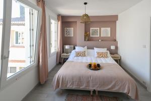 a bedroom with a bed with a bowl of fruit on it at La Belle Droite in Le Havre