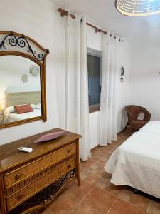 a bedroom with a bed and a mirror and a dresser at Chalet Eucaliptus in Alcossebre +39 photos