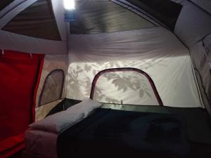 an inside of a tent with the door open at Bacalar Inn Hotel & Glamping Bacalar in Bacalar