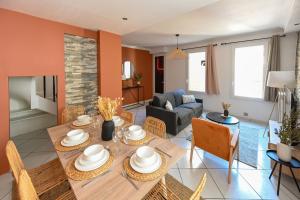a dining room and living room with a table and chairs at La Belle Droite in Le Havre