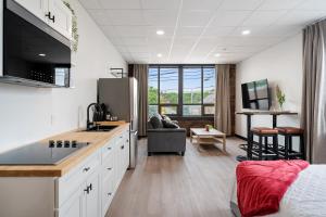 a kitchen and living room with a sink and a refrigerator at Bridge View at The MillRows Suites in New Glasgow