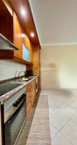a kitchen with a sink and a stove at Renaissance Sunrise Inn Algarve in Portimão