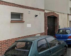 a green car parked in front of a building at La Belle Droite in Le Havre