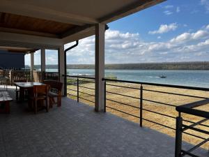a porch with a view of the beach and the ocean at Blue River, sojenica na Dunavu in Belgrade