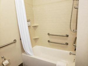 a bathroom with a tub and a shower and a toilet at Candlewood Suites MORGANTOWN-UNIV WEST VIRGINIA by IHG in Morgantown