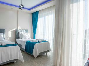 a bedroom with two beds and a blue ceiling at Villa adelina in Çavdır +20 photos