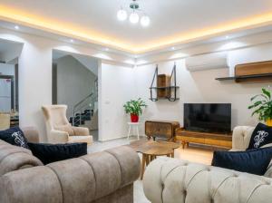 a living room with couches and a flat screen tv at Villa adelina in Çavdır