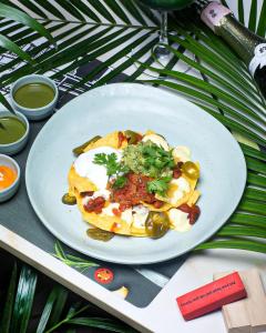 a white plate of food on a table at Hotel Mumbai House Mindspace Malad in Mumbai