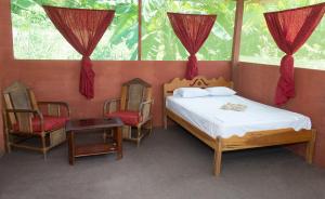 Ένα ή περισσότερα κρεβάτια σε δωμάτιο στο Maniti Eco-Lodge