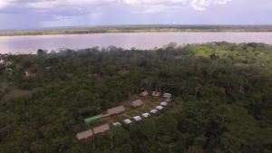 an aerial view of a house in a forest next to a river at Maniti Eco-Lodge in Francisco de Orellana
