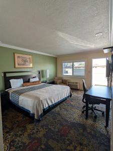 a bedroom with a bed and a desk and a desk at Cloud 9 Motel - Cypress, Buena Park in Cypress