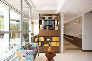 a living room with a book shelf filled with books at Hotel Z - Gaslamp San Diego in San Diego +10 photos