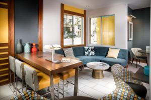 a living room with a blue couch and a table at Hotel Z - Gaslamp San Diego in San Diego