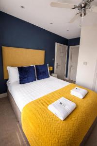 a bedroom with a large bed with two towels on it at Crescent Victoria Hotel in Margate
