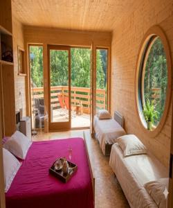 a room with two beds and a table with a tray at La Roche aux Fées in Lapte
