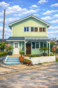 a house with a cart in front of it at ほぬのいえ Honu's house in Uruma