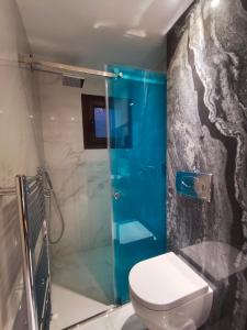 a bathroom with a toilet and a glass shower at Moumis Luxury Apartment in Limenaria +49 photos