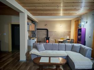 a living room with a couch and a table at Mona apartman in Žabljak