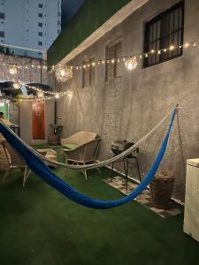 a hammock in a room with a table and chairs at Aloha Guest House in Fortaleza