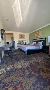 a large hotel room with a bed and a desk at Cloud 9 Motel - Cypress, Buena Park in Cypress