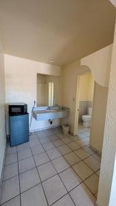an empty bathroom with a sink and a toilet at Cloud 9 Motel - Cypress, Buena Park in Cypress