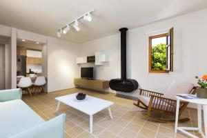 a living room with a couch and a table at Mikro Livadi Special Lodges - Has an Eco Salt water pool - 150m from the beach in Episkopi
