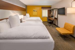 a hotel room with three beds and a chair at Hotel Z - Gaslamp San Diego in San Diego