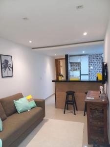 a living room with a couch and a bar at Casa ampla in Maricá