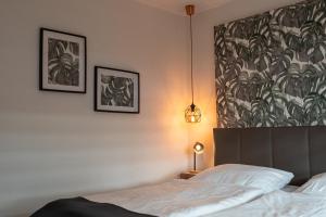 a bedroom with a bed and two pictures on the wall at Apartment Enjoy in Büsum