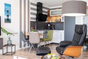 a living room with a table and chairs at Apartment Enjoy in Büsum