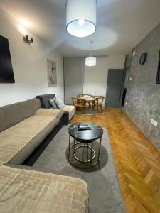 a living room with a couch and a table at Apartments Ciki in Podgorica