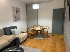 a living room with a couch and a table at Apartments Ciki in Podgorica