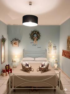 a bedroom with a bed with two wreaths on the wall at Casa vacanze Vista Castello in Oria