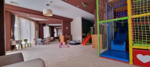 a play room with a slide and a playground at Private Apartment Lora -u sklopu Aparthotel Vučko in Jahorina
