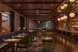 a restaurant with tables and chairs and a bar at The Compton in Bentonville
