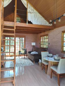 a living room with a loft bed and a couch at Cabana liberdade 2 in Rio dos Cedros