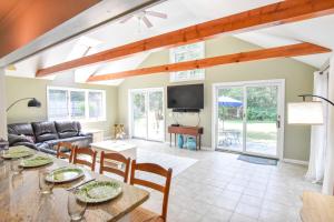 a living room with a table and a couch at Beautiful Property w Separate Apartment in Brewster