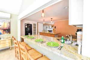 a kitchen with a counter with chairs and a sink at Beautiful Property w Separate Apartment in Brewster +29 photos