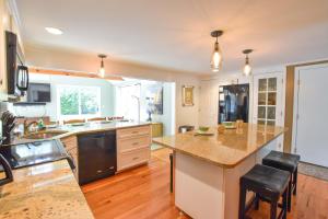 a large kitchen with a large island in the middle at Beautiful Property w Separate Apartment in Brewster