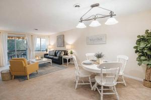 a living room with a table and chairs and a couch at The Sanctuary Company Johnson City in Johnson City