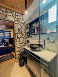 a bathroom with a sink and a bed in a room at Casa Georgia in Kefalos +17 photos