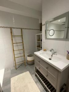 a bathroom with a sink and a mirror at L'escapade Saint Michel in Val Couesnon +22 photos