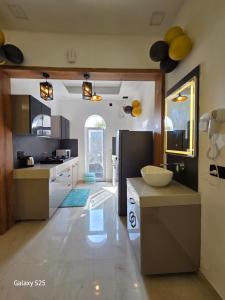 a kitchen with a counter and a refrigerator in it at Eknav Villa in Kharar