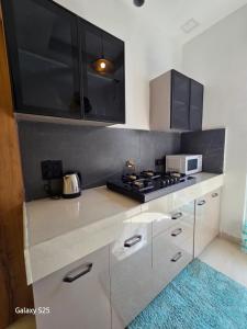 a kitchen with a stove and a counter top at Eknav Villa in Kharar