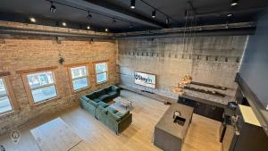 an overhead view of a living room with a couch at Downtown Loft with Rooftop Hot Tub by StayIn in Fernie
