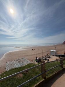 a view of a beach with a fence at Luxury 3 bed sleeps 8 caravan with sea view in Exmouth