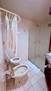 a bathroom with a toilet and a shower at Suite master, condo-hotel in Joinville +17 photos