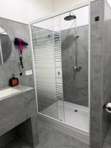 a shower with a glass door in a bathroom at Hotel MARSO in Almaty +34 photos
