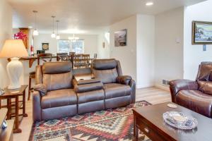 a living room with leather furniture and a table at Spacious Bandon Getaway - 2 Blocks to Ocean! in Bandon